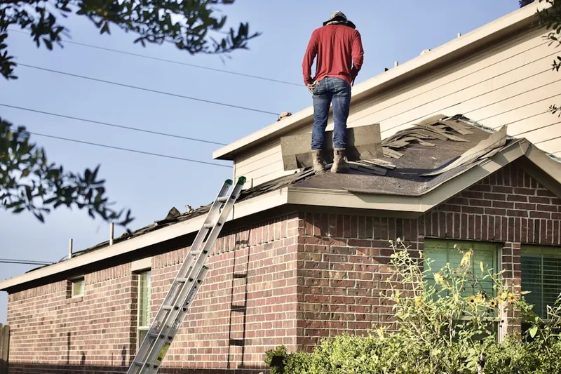 Professional roofer working on a residential roof in Hannibal Center